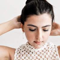 2: Model shot showing women wearing dangling earrings and a white top.