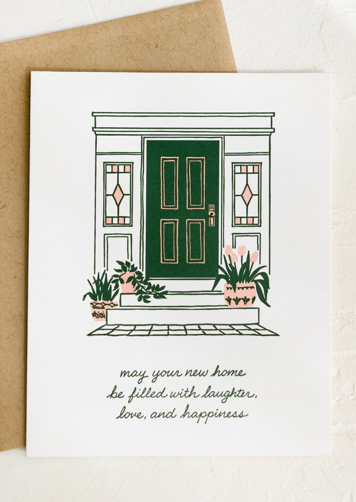 A greeting card with image of green front door, text about new home.