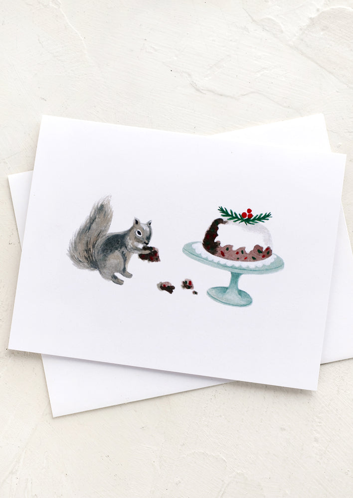 1: A greeting card with illustration of a squirrel eating holiday fruitcake off a platter.