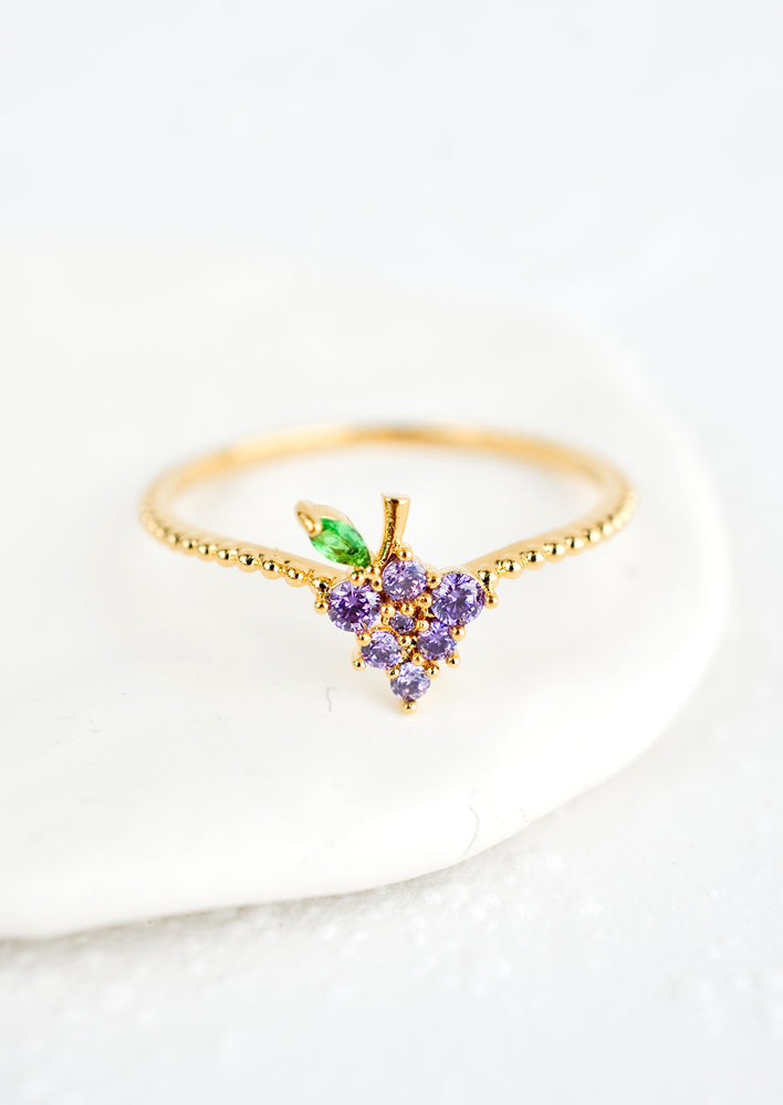 Grape / Size 5: A gold ring with beaded texture and grape shaped crystal front.