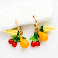 1: Gold hoop earrings with glass banana, cherry and orange fruit charms.