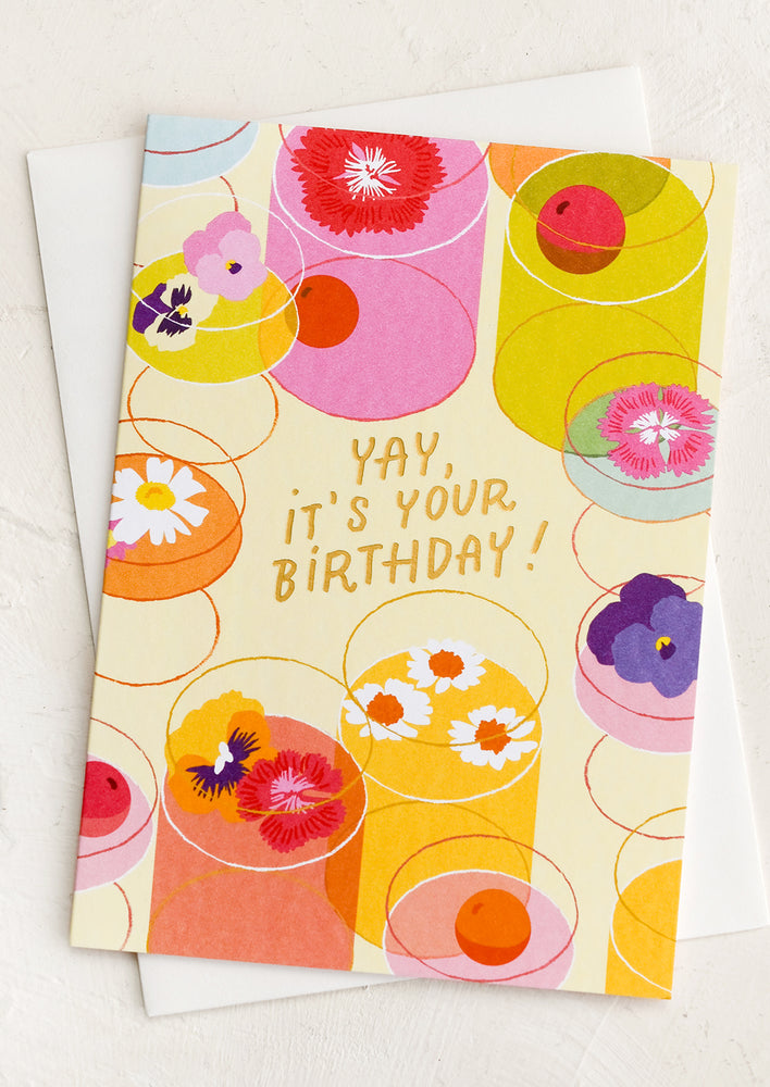 1: A card with illustration of cocktails with flowers in them, text reads "Yay, it's your birthday!".
