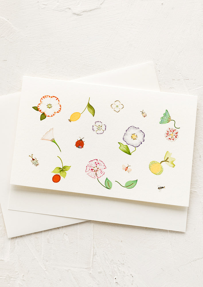 A greeting card with garden botanical illustrations.