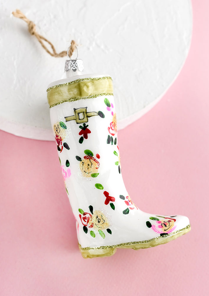 2: A decorative glass ornament in the shape of floral print garden wellies.