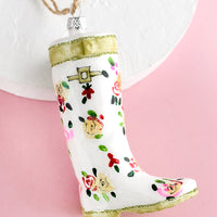 2: A decorative glass ornament in the shape of floral print garden wellies.