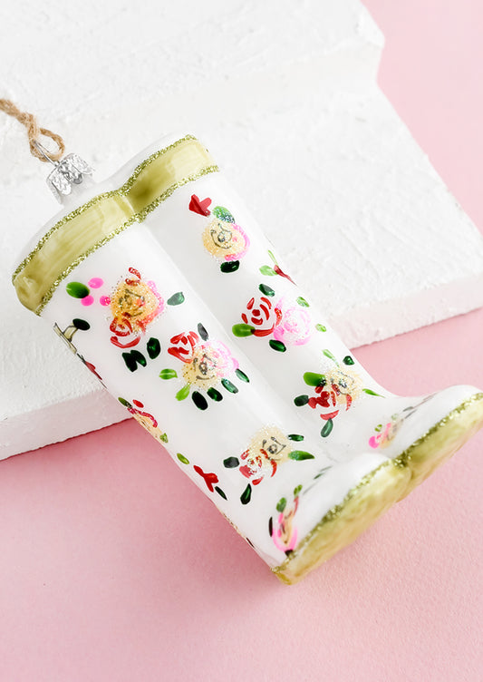 A decorative glass ornament in the shape of floral print garden wellies.