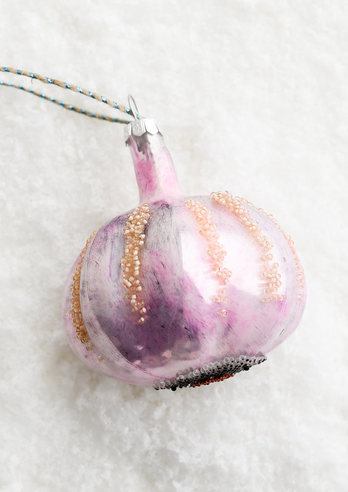A decorative glass ornament in the shape of garlic bulb.