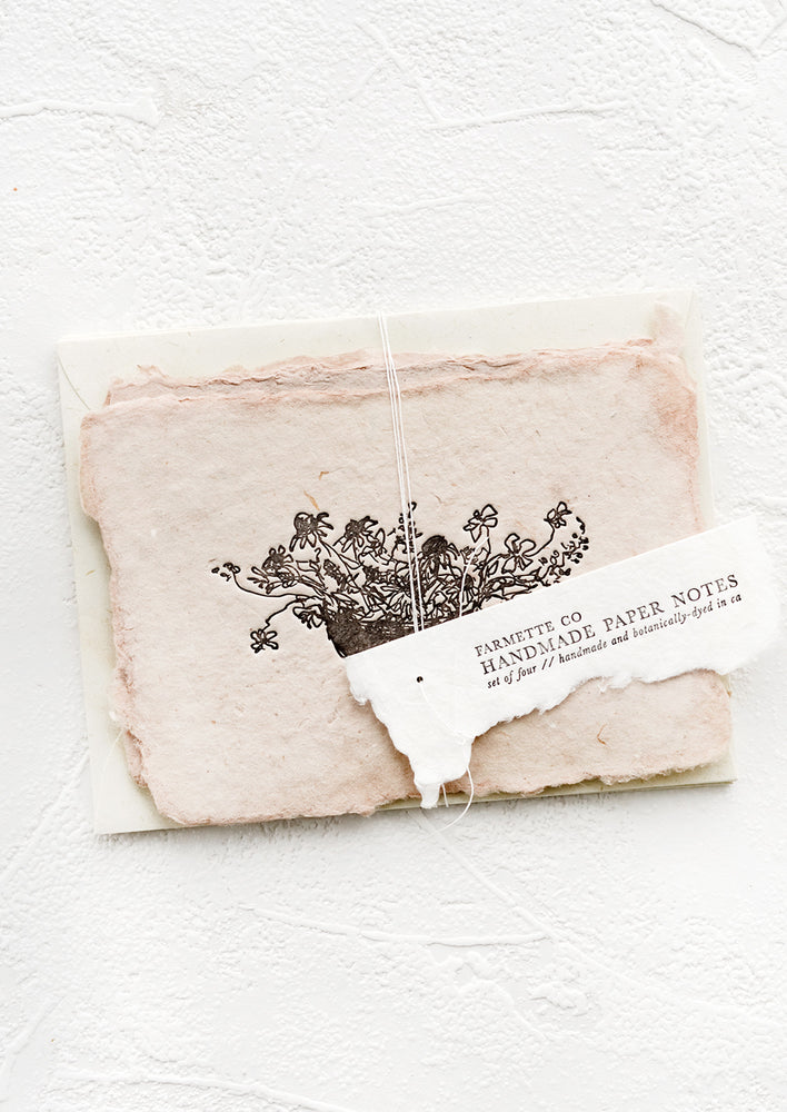 1: A packaged set of cards made from handmade paper with a letterpress printed image of flowers in a bowl.