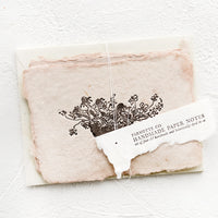 1: A packaged set of cards made from handmade paper with a letterpress printed image of flowers in a bowl.