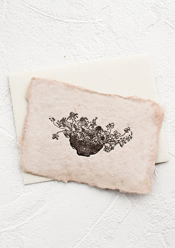 A greeting card made from handmade paper with a letterpress printed image of flowers in a bowl.
