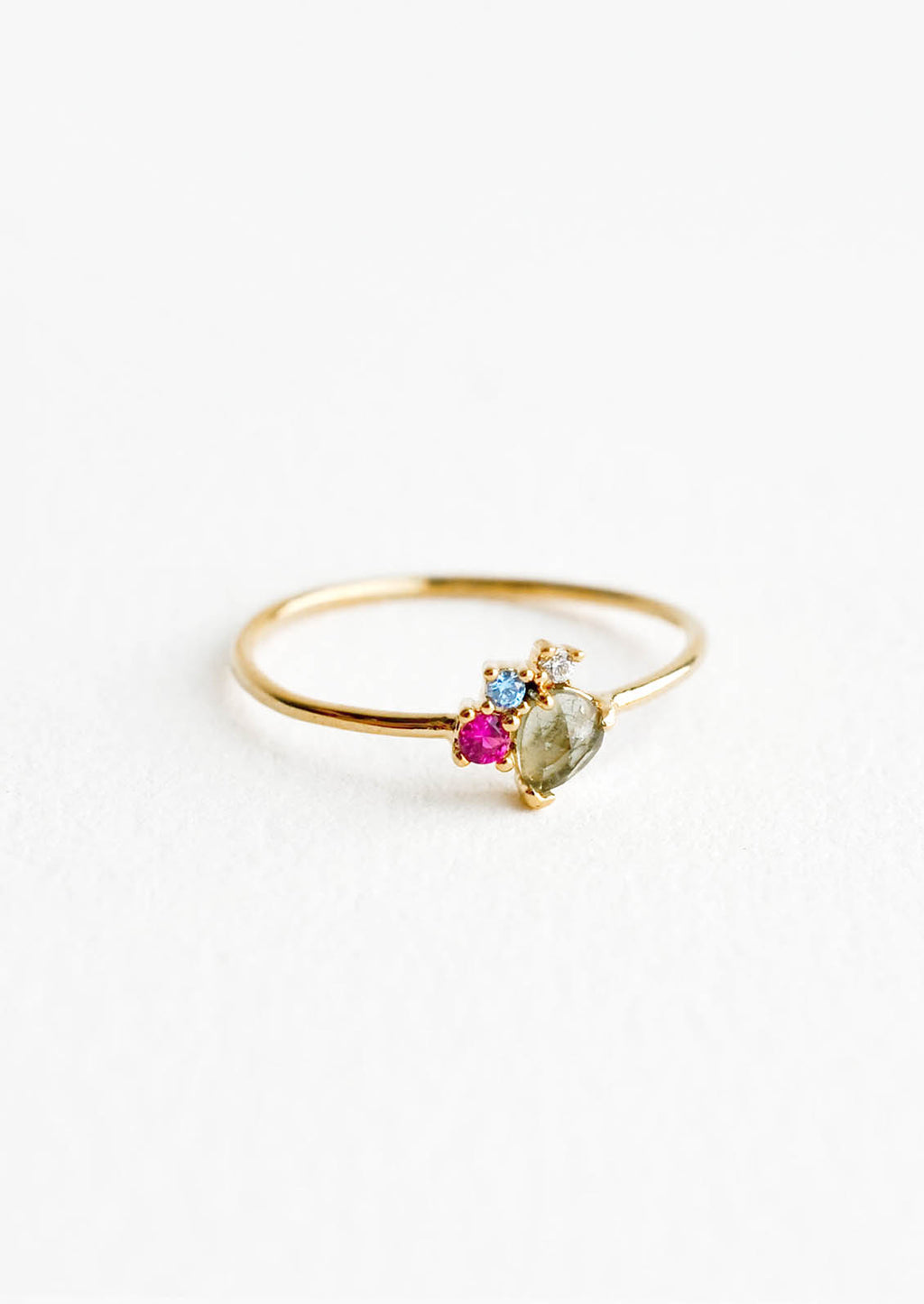 Grey Multi / Size 6: Gold ring featuring slim band with two gemstones and two crystals in pink, blue and grey hues, prong set in a cluster.