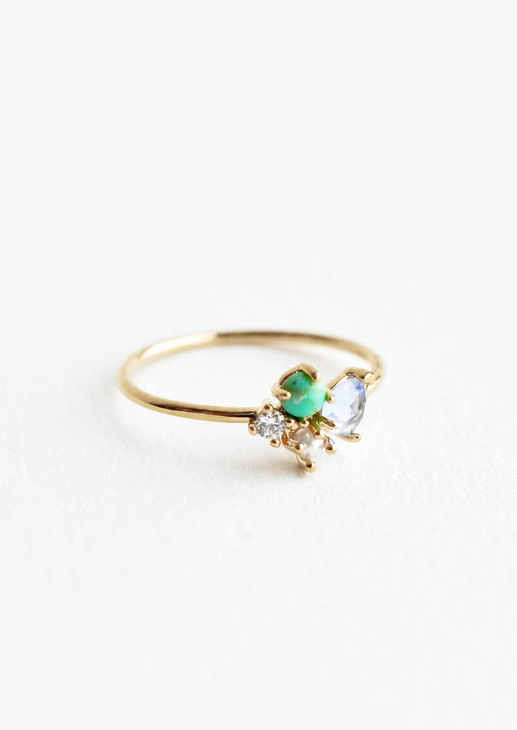 Turquoise Multi / Size 6: Gold ring featuring slim band with two gemstones and two crystals in blue, green and white hues, prong set in a cluster.