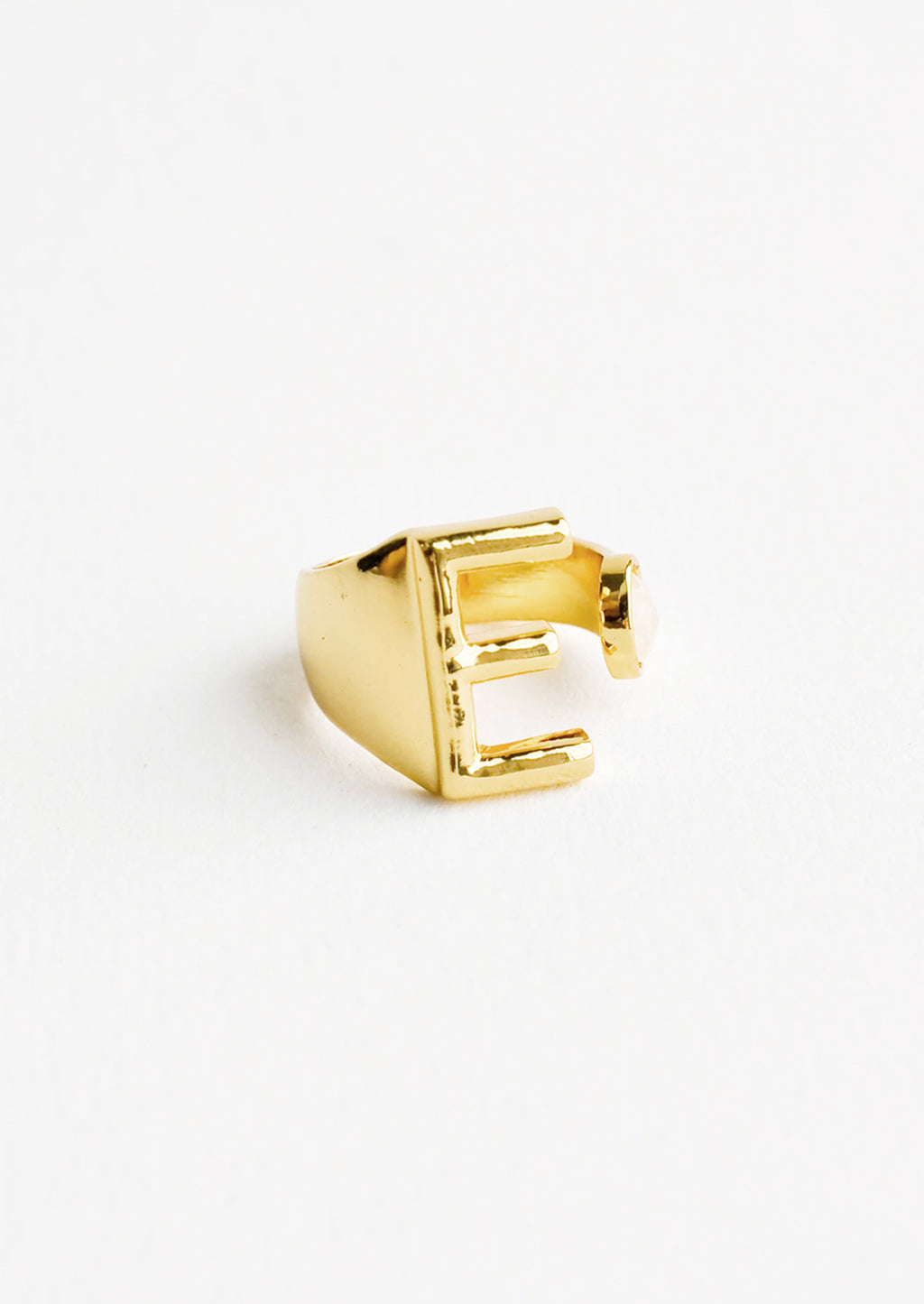 E: Yellow gold ring with letter E and oval glass crystal, and wide adjustable band.