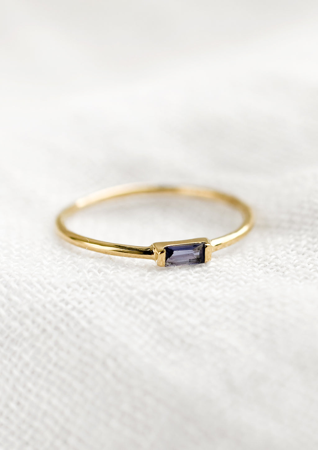 Iolite / Size 5: A gold ring with slim baguette stone in iolite.