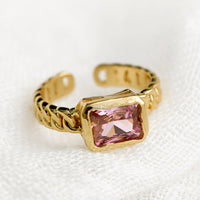 One Size / Pink: A gemstone ring with heavy chainlink band and rectangular pink baguette.