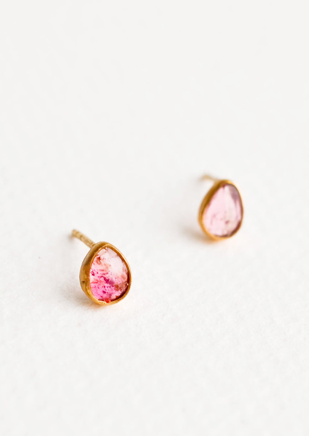 Pinks: Brass asymmetric stud earrings featuring a pink multicolored tourmaline stone.