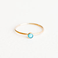 Turquoise / Size 5: Yellow gold ring with slim band and small blue turquoise stone.