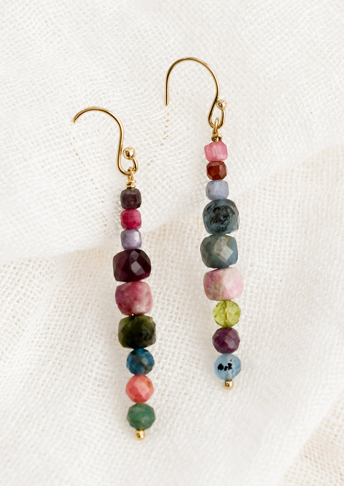 A pair of multicolor beaded mixed gemstone earrings in a straight line.