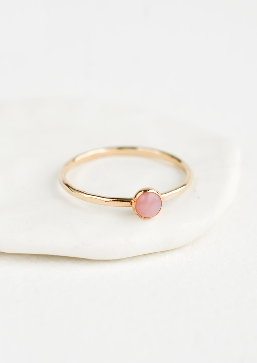 Pink Opal / Size 5: Thin gold ring with bezel set pink stone.