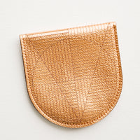 Copper: A metallic copper leather half-oval wallet with a subtle geometric pattern.