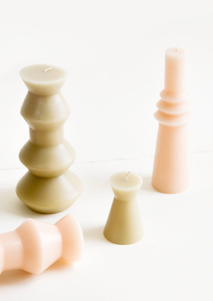 Shapely pillar candles in geometric forms, shown in a mix of shapes and sizes