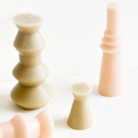 1: Shapely pillar candles in geometric forms, shown in a mix of shapes and sizes