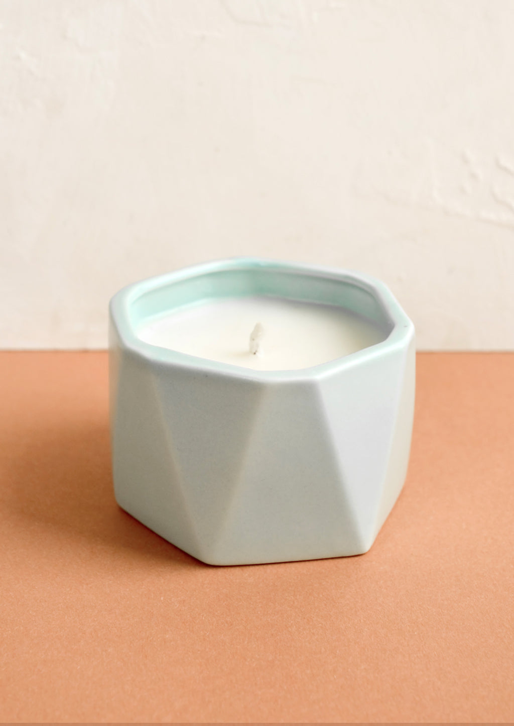 Fresh Sea Salt: A small candle in light blue faceted ceramic vessel.