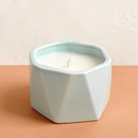 Fresh Sea Salt: A small candle in light blue faceted ceramic vessel.