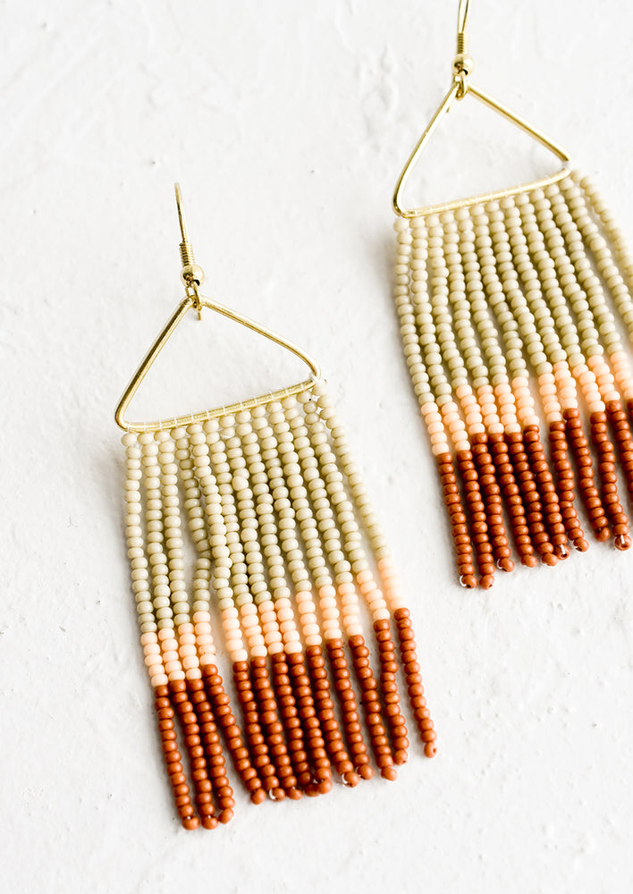 Beaded earrings with triangular metal frame and fringed beads below in colorblock pattern.