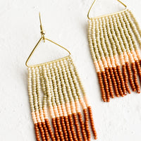 Peach / Rust Multi: Beaded earrings with triangular metal frame and fringed beads below in colorblock pattern.