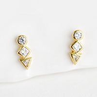 1: A pair of gold stud earrings with a circle, diamond and triangle crystal stacked in a row.