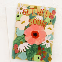 1: A lasercut floral greeting card reading 'get well soon'.