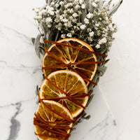 Citrus: An extra large smudge bundle with sage, white flowers and dried oranges.
