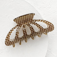 Cocoa: A gingham print hair claw in brown.