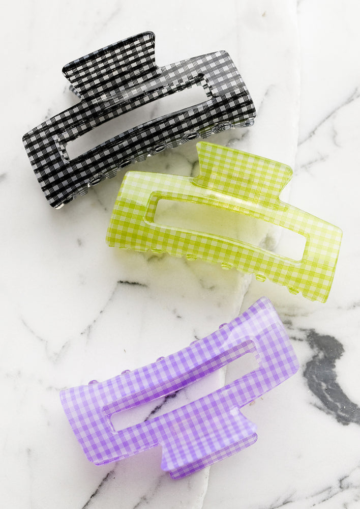 Three gingham print hair clips in assorted colors.
