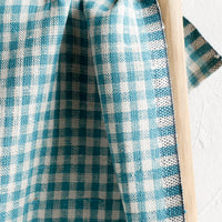 Picnic Blue: A woven gingham linen tea towel in blue turquoise color.