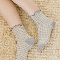 Dove Grey: A woman's ankles wearing grey gingham socks.