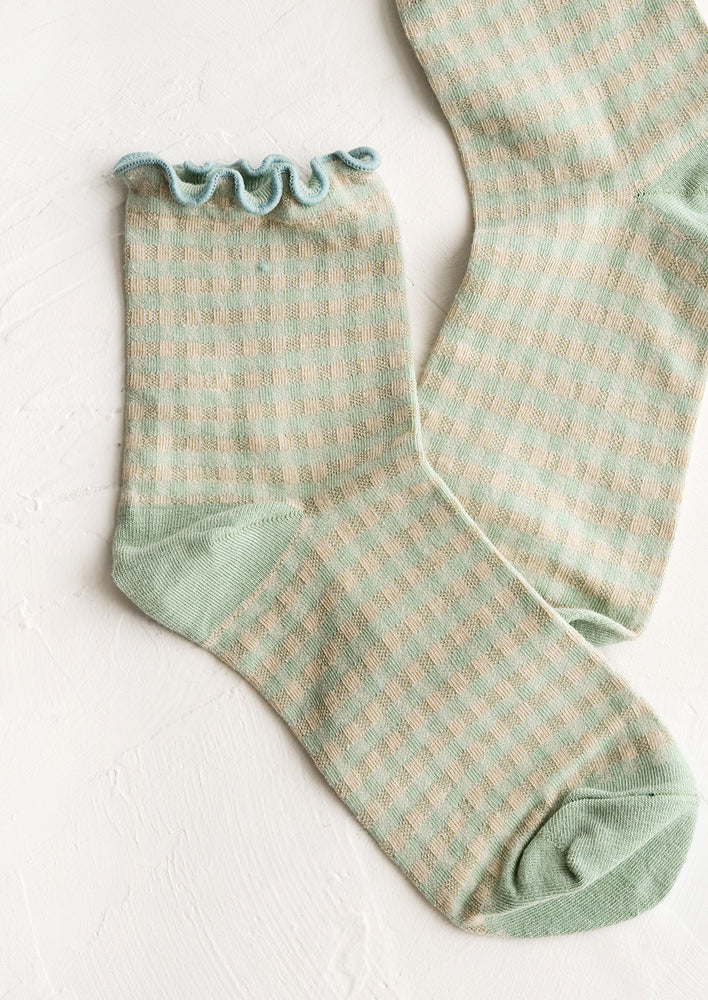 A pair of mint green gingham patterned socks with ankle ruffle.