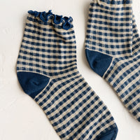 Ink Blue: A pair of dark blue gingham patterned socks with ankle ruffle.