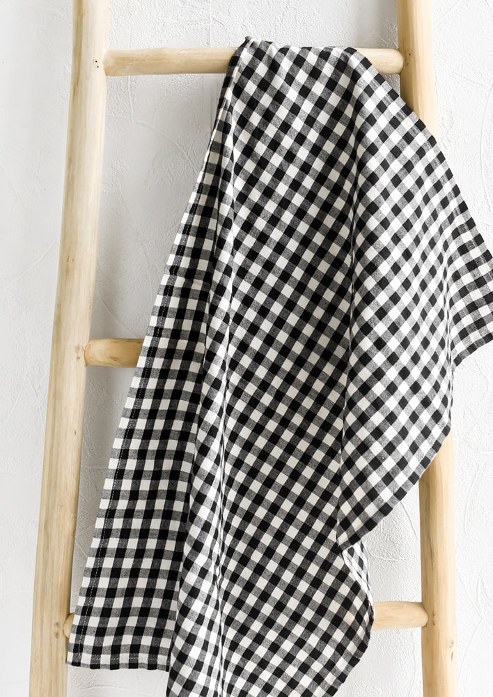 A gingham print tea towel in black and white.