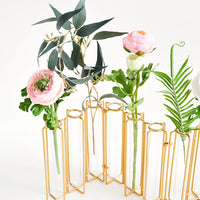Brass: Multi-stem vase composed of nine glass vials side by side, resting inside individual compartments on a brass metal frame.