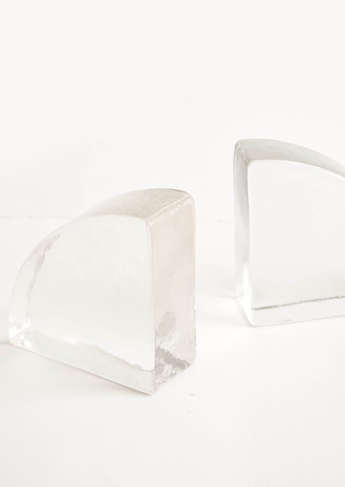 1: Solid clear glass bookends shaped in a quarter-quadrant of a circle