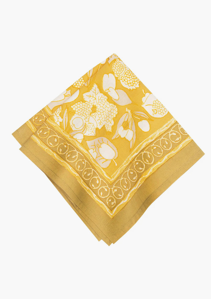 5: A pair of mustard/gold napkins with fruit print.