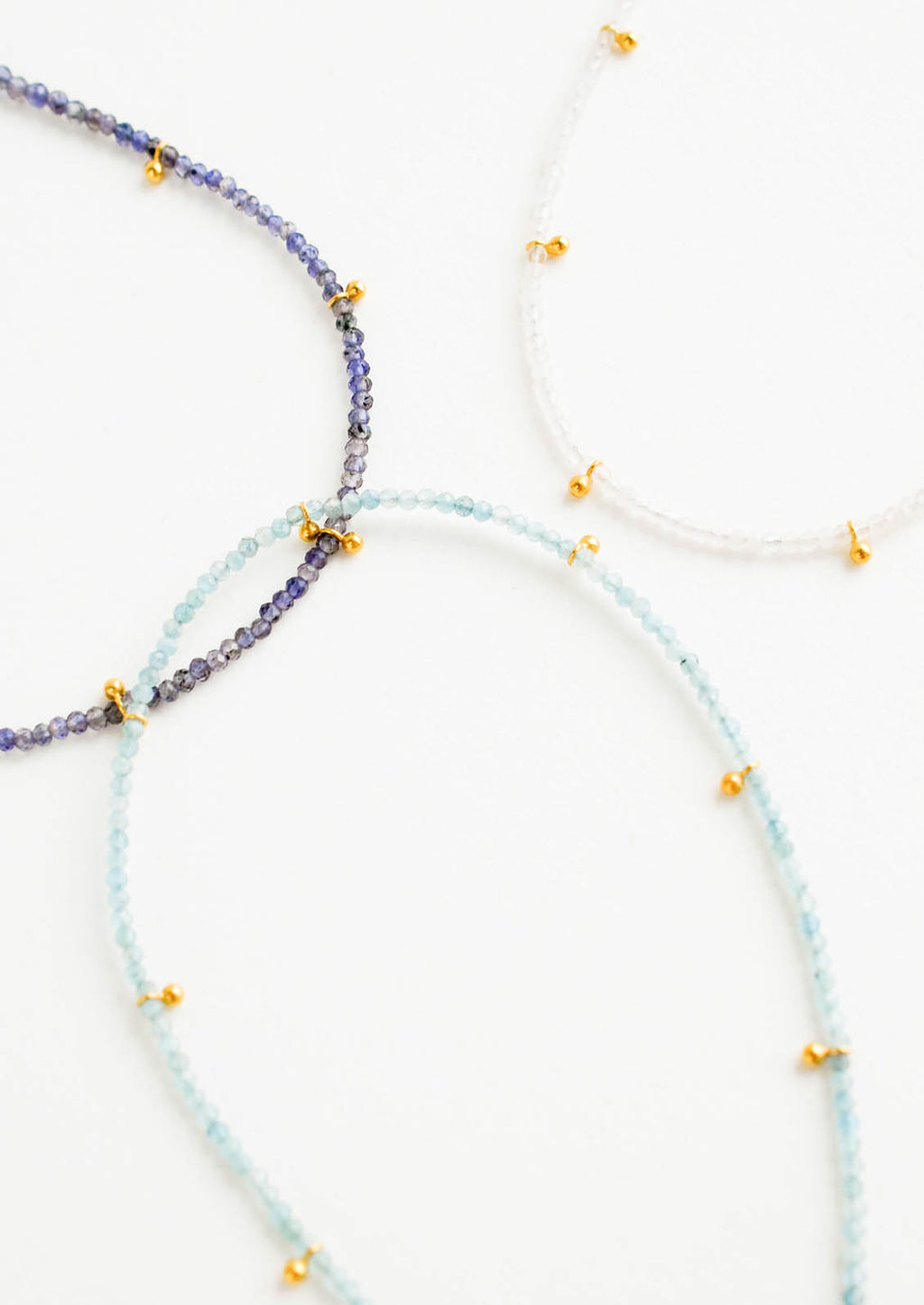 1: Three necklaces of gemstones and gold beads.