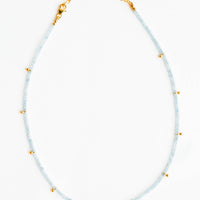 Aqua Chalcedony: A necklace of clear blue stones with evenly spaced gold beads and a golden chain clasp.