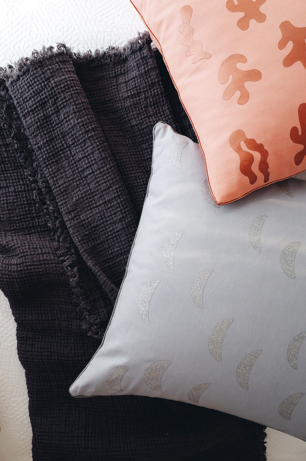 2: Stylized Image of Two Printed Pillows on Bed - LEIF