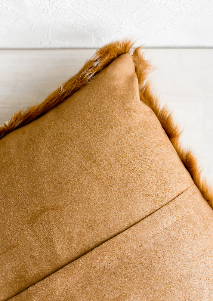 A brown faux suede pillow back with concealed zip.