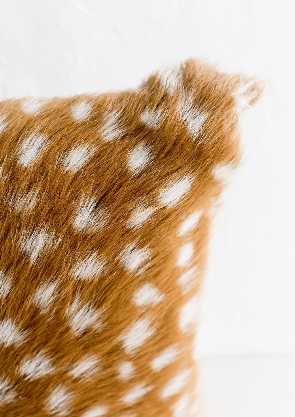 3: A pillow made from spotted goat fur.