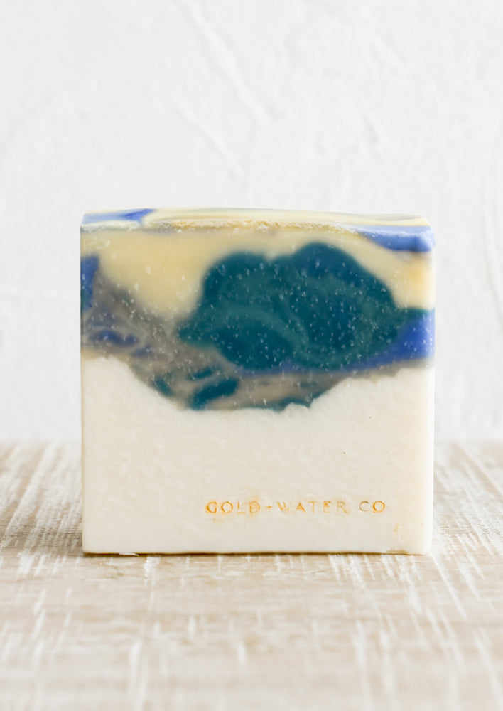 A bar of soap in ivory, yellow and blue.