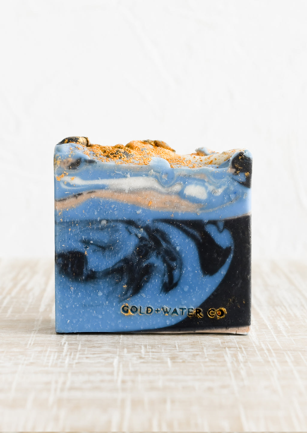 Closer: A bar of soap in blue, gold and black.